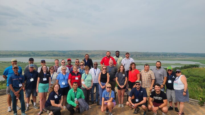 Group in front of large water