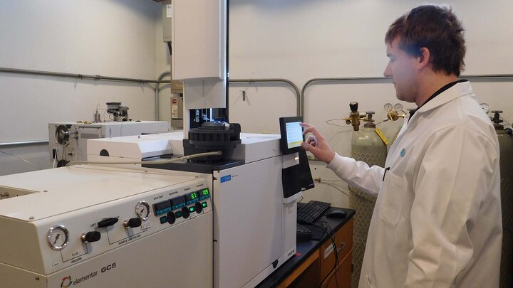 Person working on laboratory equipment