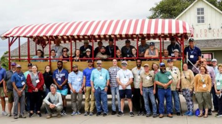 Group in front of open bus