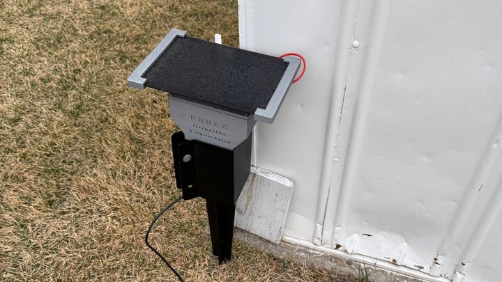 Solar panel mounted on side of wall outdoors