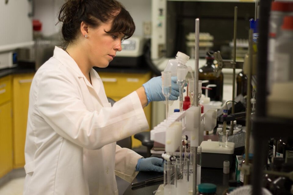 Person working on laboratory equipment